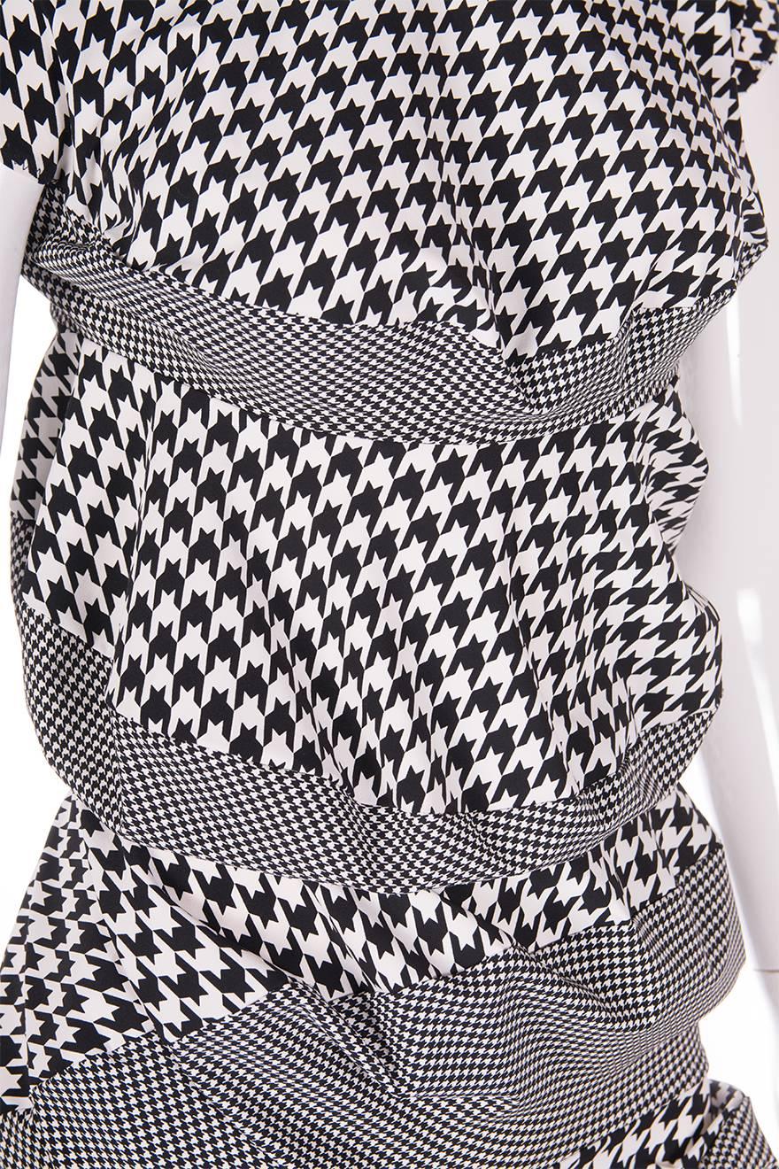 Houndstooth and check dress by Comme Des Garcons.  This particular dress has a unique accordion style shape.  

Marked size S
To fit S

Excellent condition demonstrating little to no signs of visible wear.  This dress is 
