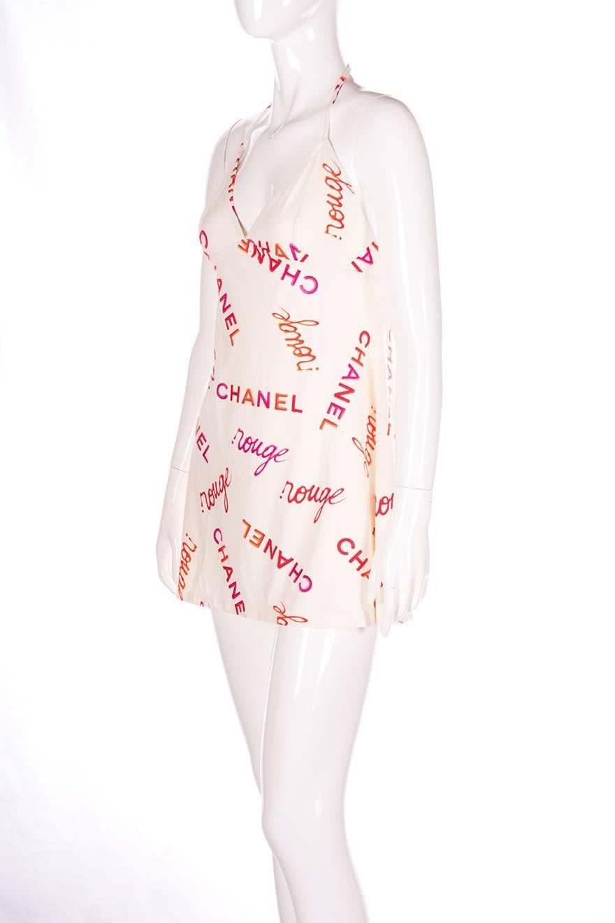 Cream mini halter dress by Chanel in an allover logo print.  Mini length.  Adjustable halter neck.  Circa 90s.

Marked size: 40
To fit: S-M (runs small)

Measurements
Chest: 36-45 cm
Length: 79 cm

Please note there is a significant degree