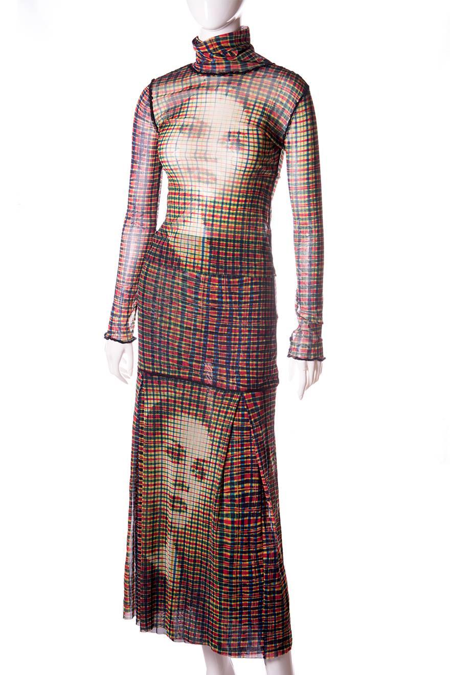 Jean Paul Gaultier sheer mesh turtleneck and skirt set.  Deconstructed style with seams on the outside of the garment.  Raw hem.  Pleated, ankle length skirt.  The skirt hugs the body on the hips and the pleating starts at the thighs.  Skirt is