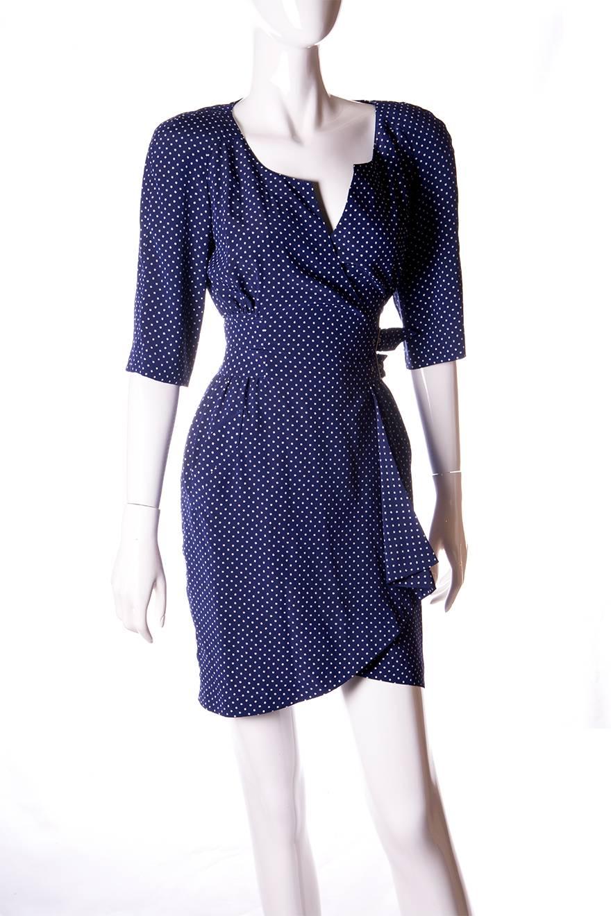 Wrap style dress by Thierry Mugler featuring a print with tiny stars.  Exaggerated shoulders.  Belted waist with double buckle.  Circa 80s.

Marked size: No marked size
To fit: XS-S

Measurements:
Chest: 42 cm
Waist: 31 cm
Length: 86