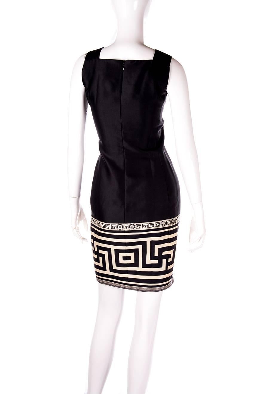 Monochrome shift dress by Gianni Versace with a Greek key design at the bottom.  Wool silk blend.  The dress has a sheen which doesn't show up in our images.  Circa 90s.
 
Excellent condition demonstrating little to no signs of visible