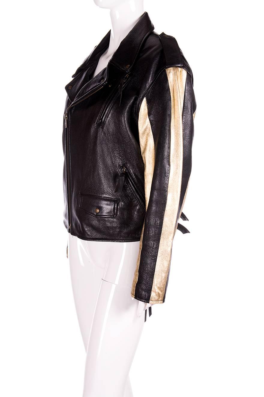 Stunning leather biker jacket by Moschino Leather with contrast gold sleeves.  Gold satin lining.  Interior pockets.  Circa 80s.

Excellent condition demonstrating little to no signs of visible wear, some minor wear on the lining.

Marked size: