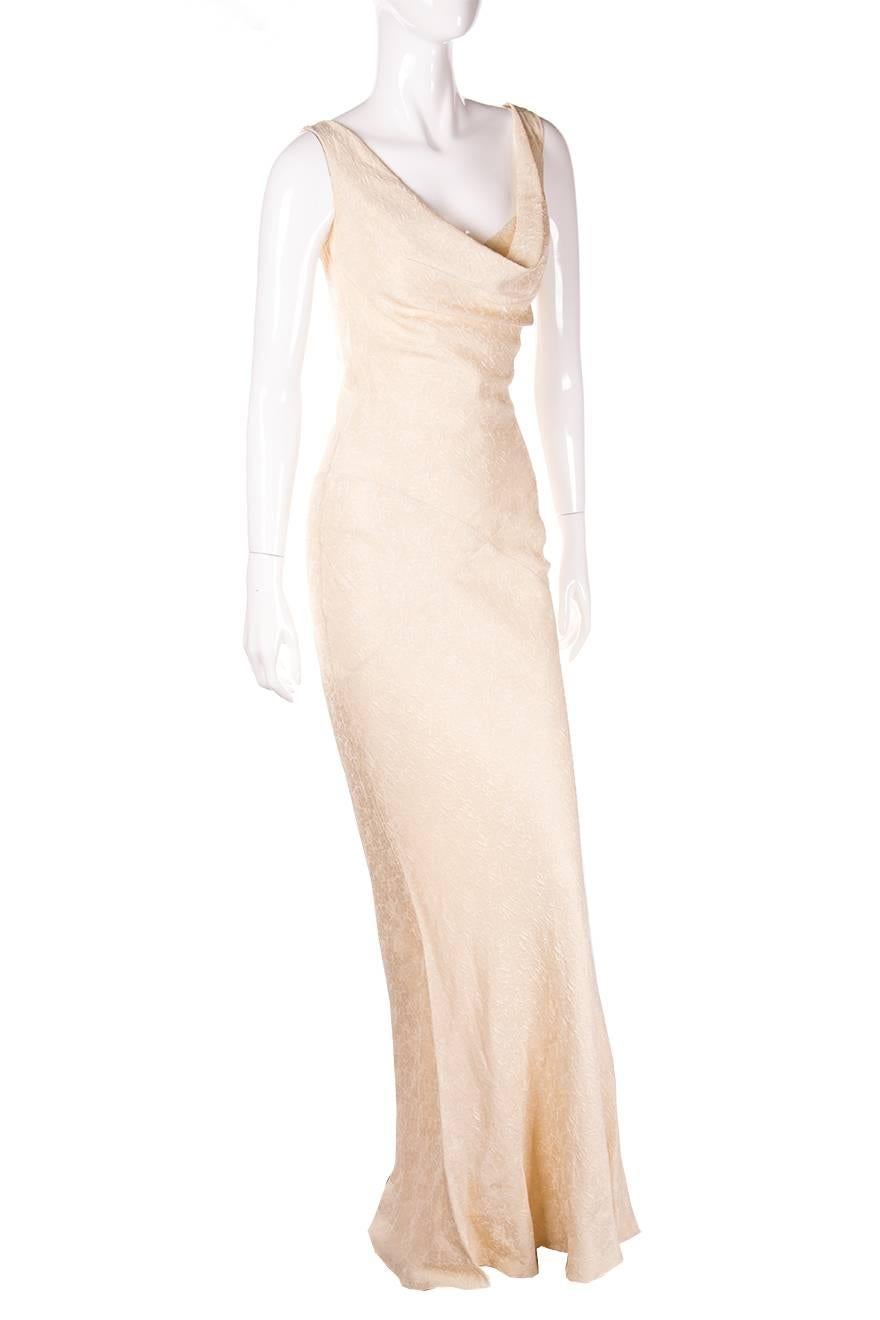Elegant full length dress by John Galliano in cream and gold brocade.  Extremely flattering cut.  Plunging back.  Circa early 00's
Excellent condition demonstrating little to no signs of visible wear

Marked size: No marked size
To fit: