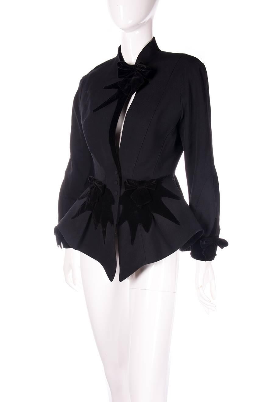 Incredible sculpted jacket by Thierry Mugler with velvet detail.  The front of the jacket has a risque peekaboo cutout. Velvet bows on the cuffs and at the front of the jacket.  Circa 80s
Excellent condition demonstrating little to no signs of