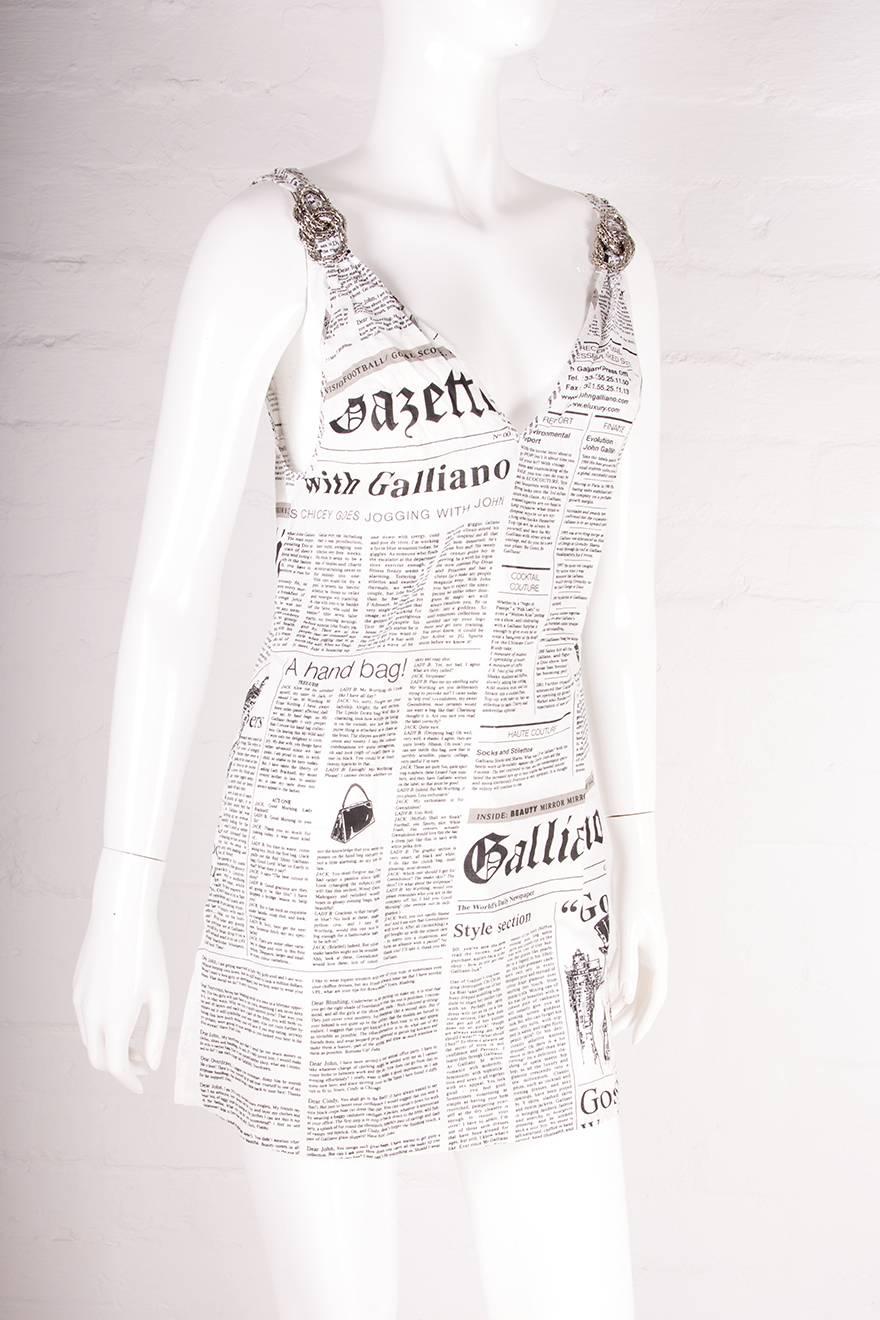 Dress by John Galliano in the iconic newspaper print.  Circa early '00s.  Splits at the side of the dress. Plunging neckline.  Cotton fabric.

Excellent condition demonstrating little to no signs of visible wear


Marked size: XS
To fit: XS-S
Chest: