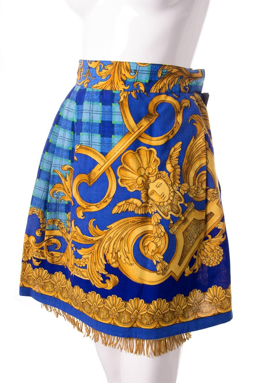 High waisted skirt by Gianni Versace in a vibrant baroque and plaid print. Wrap style. Gold fringe at the hem. Circa 90s.   

Excellent condition demonstrating little to no visible signs of wear. This skirt still has its original tags attached.


