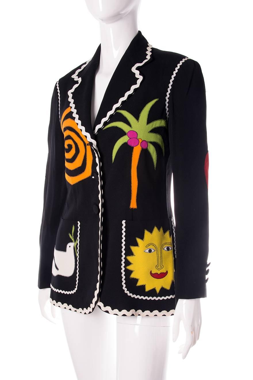 Single breasted blazer by Moschino Cheap and Chic. Lined in striped fabric. Huge applique wreath at the back.  

Very good condition demonstrating a few visible signs of wear. Some wear at the bottom of the jacket.

 Marked size: 44 (IT)
To fit: S-M