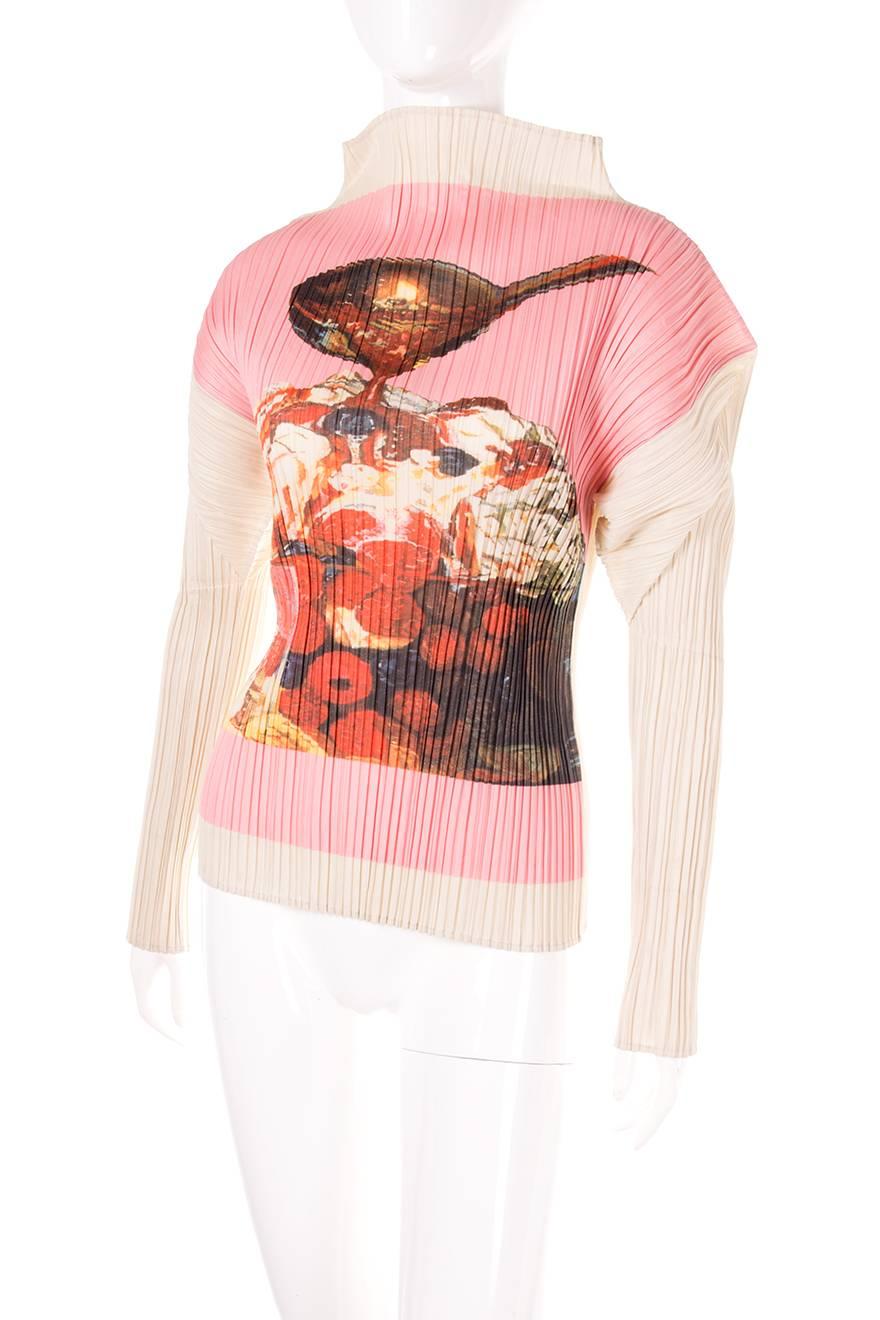 Fruit/dessert print top by Issey Miyake. Bold exaggerated shoulders. Signature Issey Miyake pleated fabric. Circa 90s.

Excellent condition demonstrating little to no visible signs of wear.

Marked size: No marked size
To fit: S
Chest: 42-48