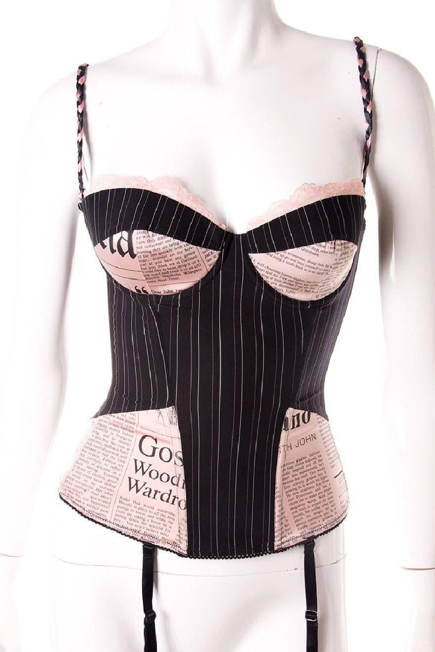 Rare newspaper print corset by John Galliano.  Pink satin newspaper print fabric + pinstripes. Adjustable straps. Circa early 00's.

Excellent condition demonstrating little to no visible signs of wear.

Marked size: 70C/32C

To fit: S

 

Chest: 37