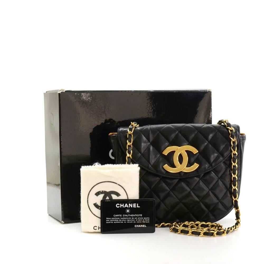 Chanel Black quilted leather shoulder bag. It has a flap with large CC stud closure on the front. Inside has Chanel red leather lining with 1 open pocket. It can be carried on shoulder or across body. 
Made in: France
Serial Number: 0615449
Size: