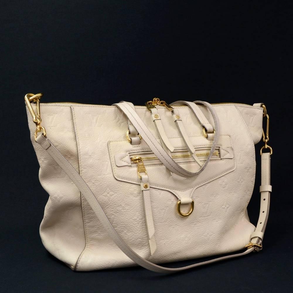 Louis Vuitton Empreinte Lumineuse in white leather. It has 2 zipper pocket on front. Top is secured with zipper. Inside has canvas lining with 1 zipper and 2 open pockets. Can be carried as hand bag or shoulder bag. Great for daily use. 

Made in: