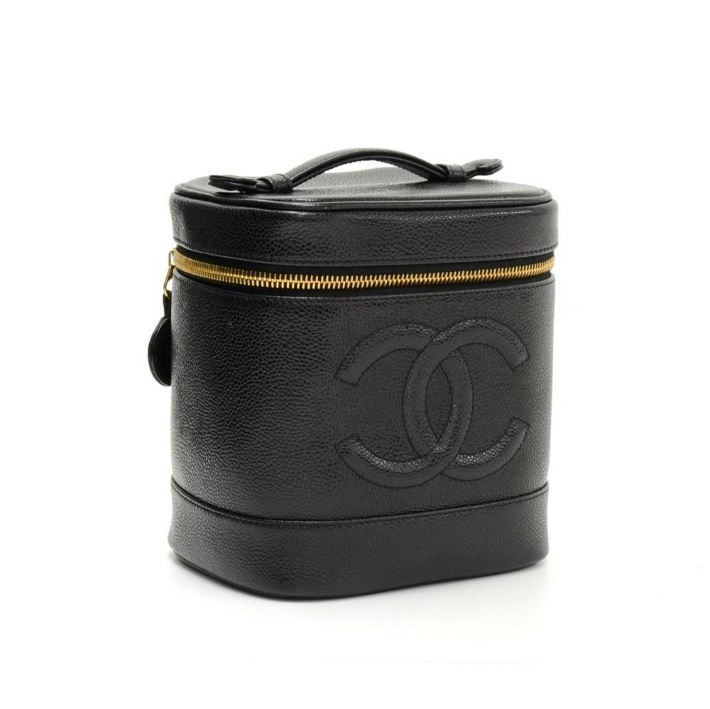 Chanel vanity cosmetic bag in black caviar leather. Top is secured with zipper. Inside is in black lambskin lining and one open pocket. Carried in hand. Simple and functional. 

Made in: France
Serial Number: 6766883
Size: 5.9 x 6.5 x 4.9 inches