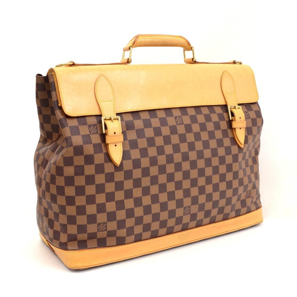 Louis Vuitton Clipper travel bag in Damier Canvas. This is 100th Anniversary Limited Edition from Louis Vuitton. It has flap with 2 belt closure in front. Inside is in brown lining with 1 large pocket with zipper. A great companion wherever you go.