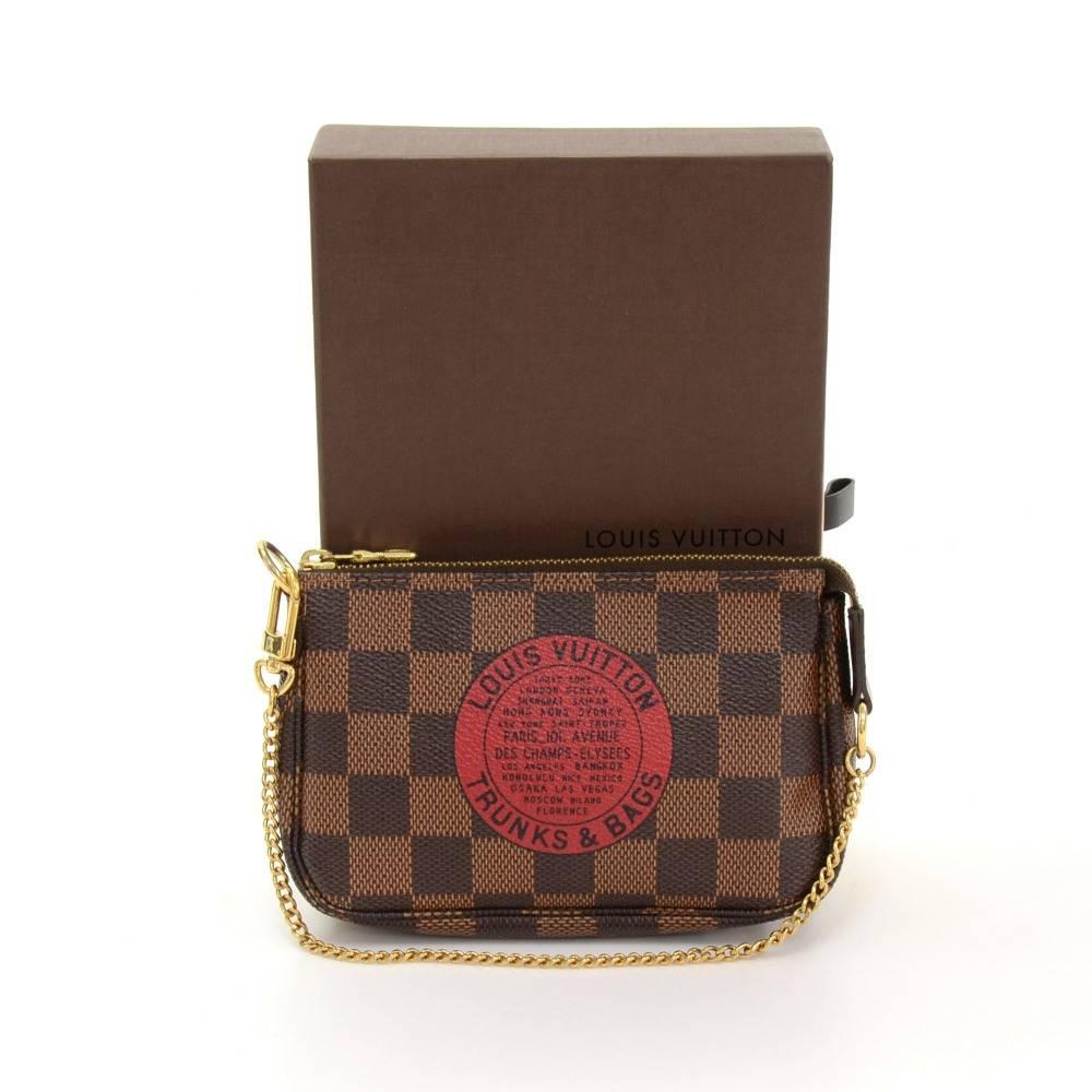 Louis Vuitton mini pouch in Damie canvas. Perfect for night out and parties. It can be either hand-held or linked to the D-ring found in many Louis Vuitton.

Made in: France
Serial Number: FL0098
Size: 5.9 x 3.9 x 1.2 inches or 15 x 10 x 3