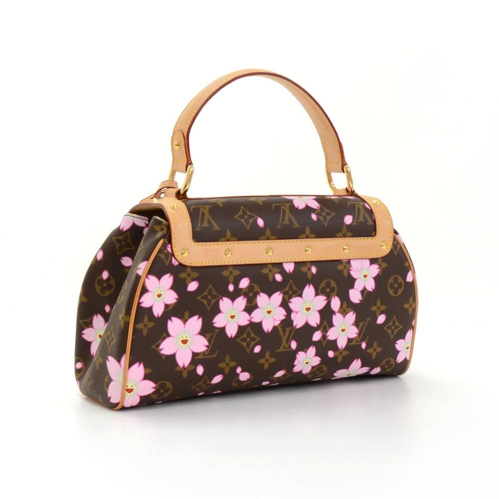 Louis Vuitton Sac Retro PM in monogram cherry blossom motif is limited edition from 2003. This gorgeous handbag is crafted from monogram canvas, accented with leather handles. Centered bow with golden lock and trimmed with golden studs. Very cute
