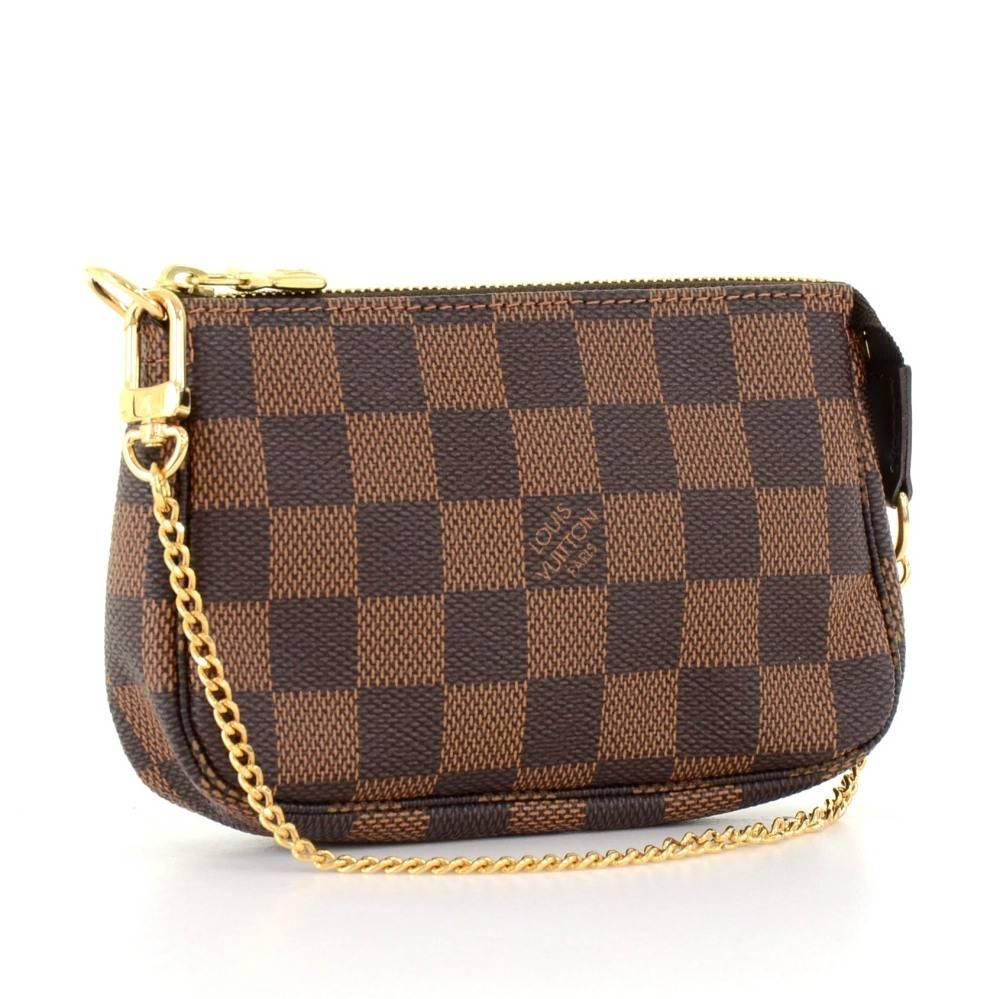 Louis Vuitton mini pouch in damier canvas. Perfect for night out and parties. It can be either hand-held or linked to the D-ring found in many Louis Vuitton.

Made in: France
Serial Number: FL1006
Size: 5.5 x 3.7 x 1 inches or 14 x 9.5 x 2.5