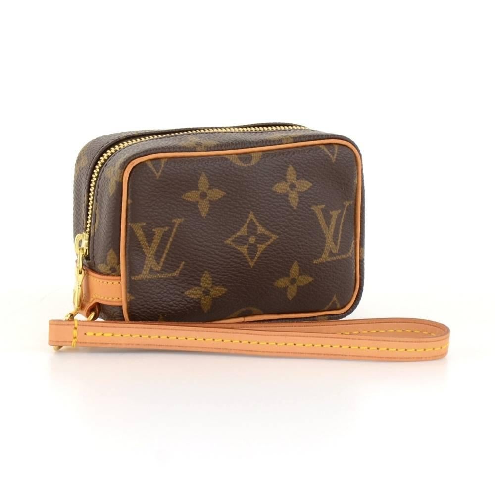 Louis Vuitton Trousse Wapity case in monogram canvas. Comes with a short removable leather strap. Inside is in red alkantra lining and has open pocket. Great to keep many things secured like phones, cameras, cards, cosmetics and keys. It would make