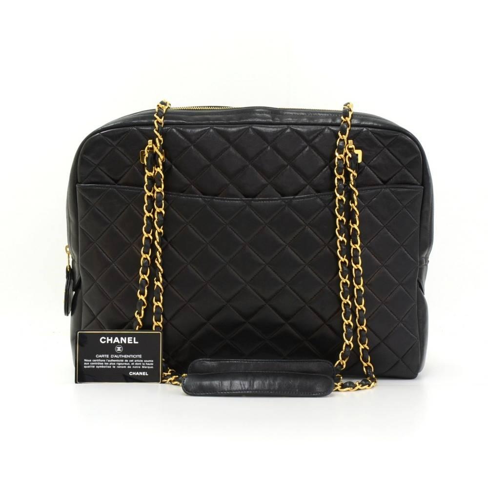 Chanel black quilted leather shoulder tote bag. It has zipper closure and 1 exterior open pocket on each side. Inside has Chanel red lining and 2 open pockets. Comfortably carry on shoulder and offers great capacity. 

Made in: France
Serial