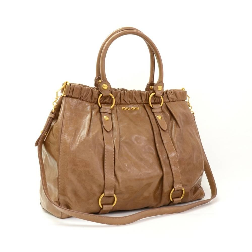 Miu Miu Vitello Lux 2way bag in brown leather. It has stud closure on top. Inside has black lining with 1 zipper and 1 open pocket. Great for daily use! 

Made in: Italy
Serial Number: 142
Size: 16.1 x 12.6 x 5.5 inches or 41 x 32 x 14