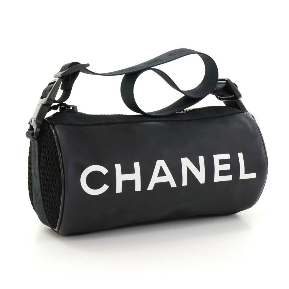Chanel sports bag in black rubber x nylon. Main area is secured with zipper. Inside has 1 zipper pocket and nylon lining. Very stylish and cute for any purpose.  

Made in: Italy
Serial Number: 8945040
Size: 9.8 x 5.1 x 5.1 inches or 25 x 13 x