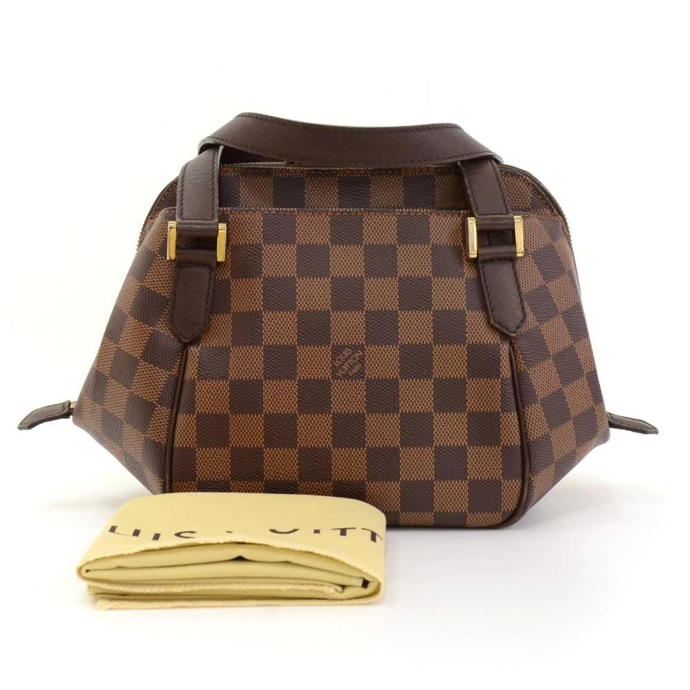 Louis Vuitton Belem PM hand bag in brown Damier canvas. Top is secured with double zipper. Outside has 1 open slip pocket on each side. Inside has red canvas lining. Stay organized in style!

Made in: Spain
Serial Number: AR0035
Size: 9.8 x 7.5
