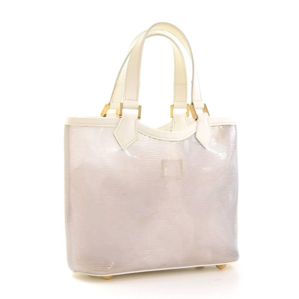 Louis Vuitton white vinyl mini Lagoon beach bag. It is from the limited collection from the years 2003. Open access with 1 open pocket. Extremely rare bag to find. It comes with small pouch

Made in: Spain
Serial Number: CA0032
Size: 9.4 x 8.1 x