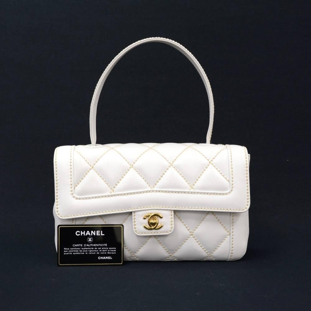 Chanel handbag in lambskin leather wild stitch. It has flap with CC logo twist lock on the front and 1 open pocket on back. On the inside, it has 1 exterior open pocket, 1 interior zipper pocket and 1 for mobile. Very stylish and classic Chanel