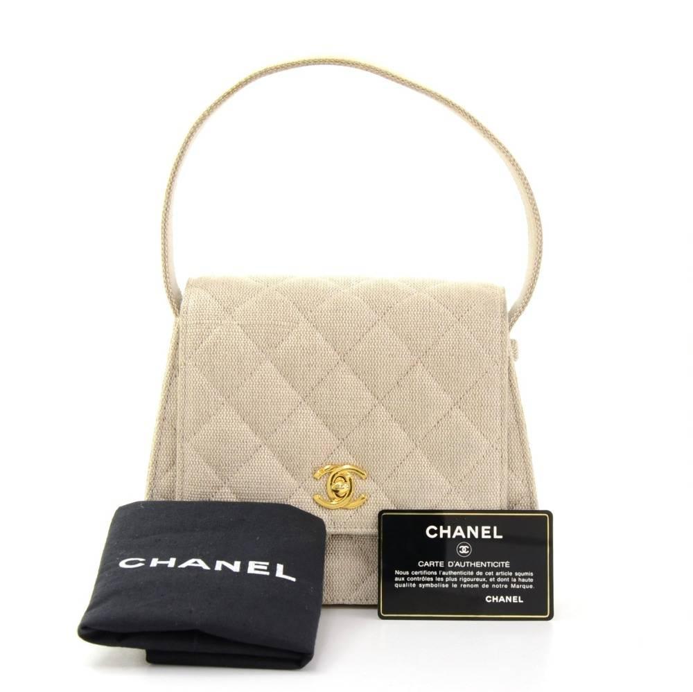 Chanel beige canvas handbag. It has flap with CC twist lock on front. Inside has lambskin lining 1 zipper and 1 open pocket. Very cute bag.

Made in: France
Serial Number: 5277218
Size: 6.7 x 5.9 x 2.8 inches or 17 x 15 x 7 cm
Color: