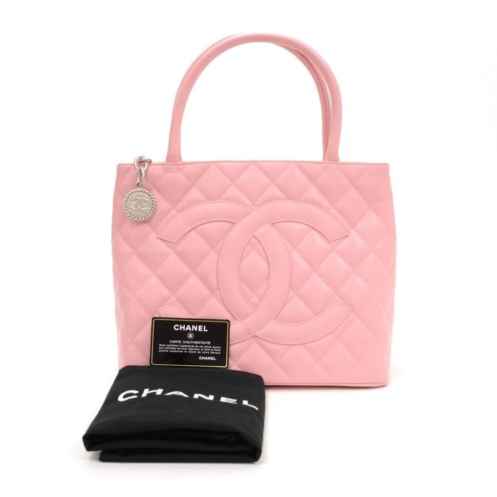 Chanel Revival tote in pink quilted caviar leather. Large CC stitched in front and slip in pocket on the back. Top secured with zipper closure and medallion on chain as zipper pull. Inside has leather lining and 2 pockets: 1 zipper and one open.