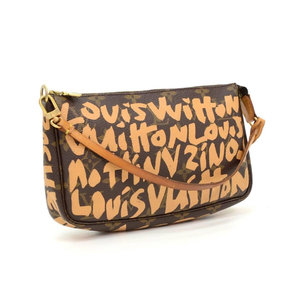 Louis Vuitton pochette accessories in monogram graffiti collection from 2001. It stores beauty products and other daily essentials. Perfect for night out and parties. It can be either hand-held or linked to the D-ring found in many Louis