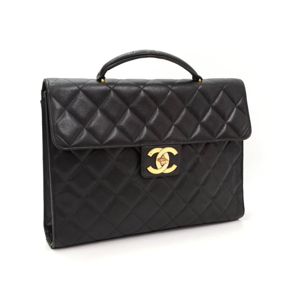 Chanel Handbag / briefcase in black caviar quilted leather. On the back is large slip in pocket. Flap top is secured with large CC hardware twist lock. Inside is leather lining with 2 pockets: 1 open and 1 with zipper. Wonderful classic design would