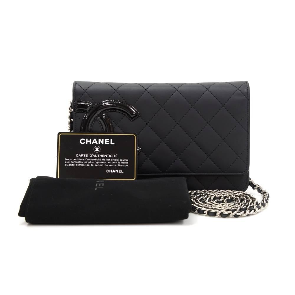 Chanel Cambon black leather wallet on chain. It has flap top with a secure stud. Inside has 1 compartment for coin with zipper closure, 1 note compartment, 2 open pockets, and 6 card holders. It has long chain intertwined with leather. Very