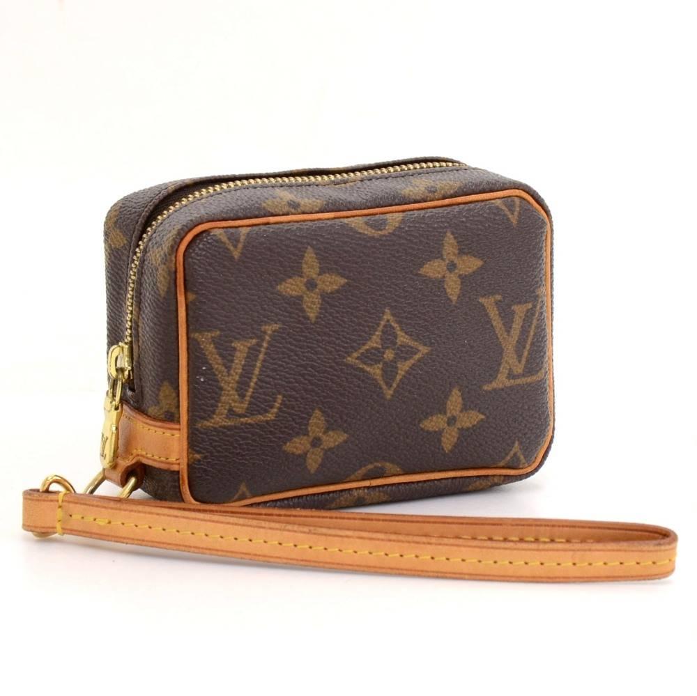 Louis Vuitton Trousse Wapity case in monogram canvas. Comes with a short removable leather strap. Inside is in red alkantra lining and has open pocket. Great to keep many things secured like phones, cameras, cards, cosmetics and keys. It would make