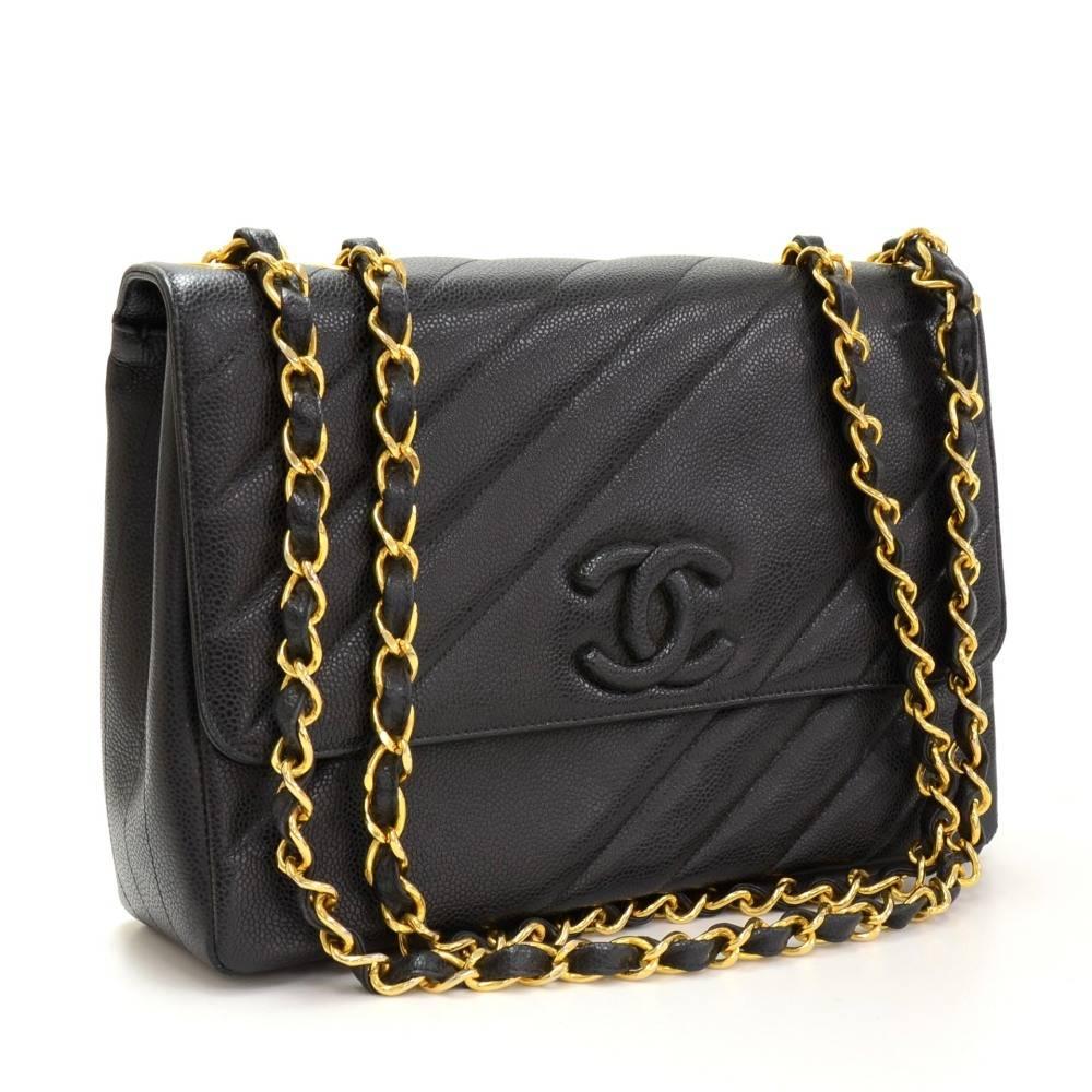 Chanel bag in black quilted caviar leather. It has flap with large CC magnetic lock and open pocket on the back. Inside has leather lining and 2 pockets: 1 zipper and 1 open. Comfortably carried on shoulder and offers great capacity.

Made in: