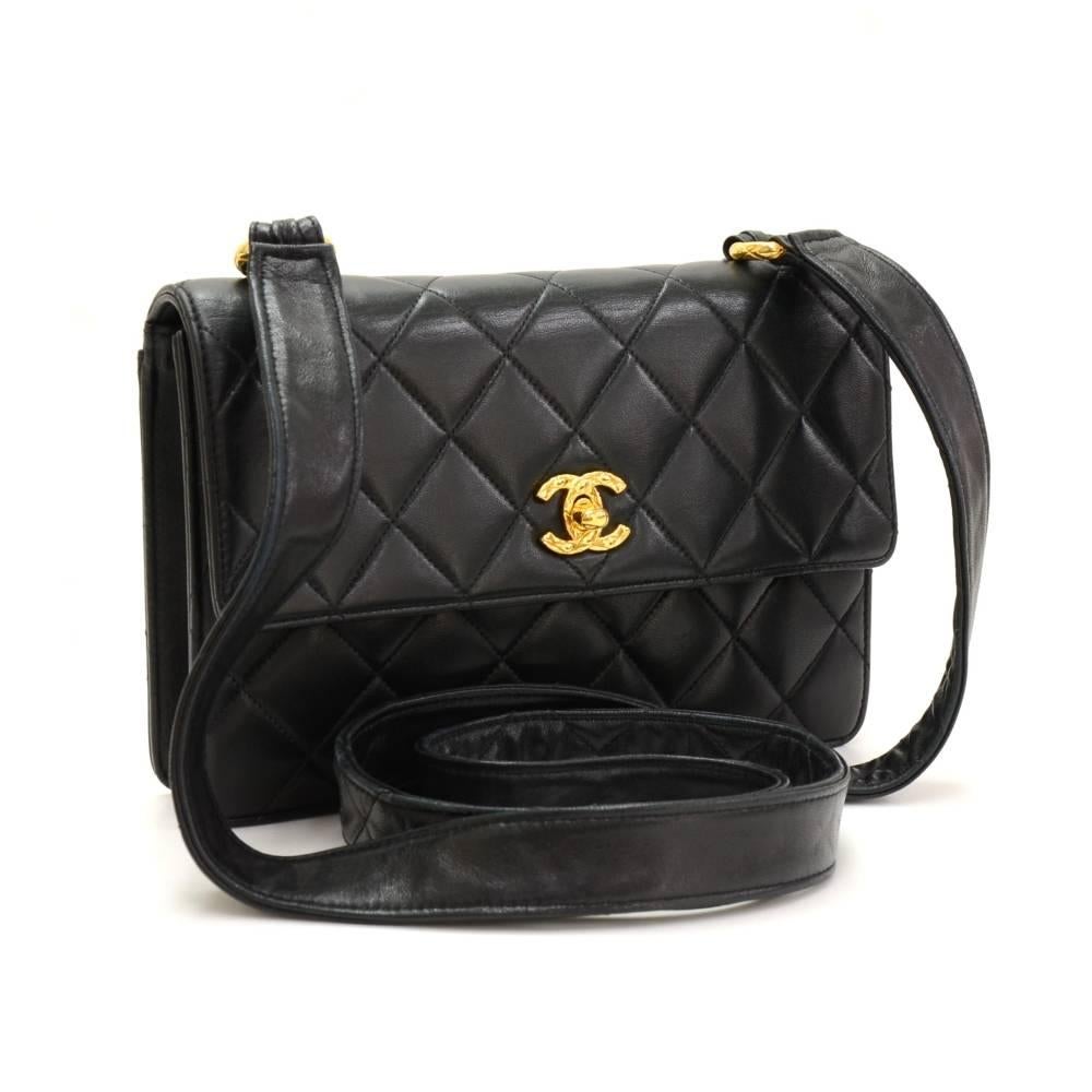 Chanel shoulder bag in black quilted leather. It has flap with CC twist lock on front and 1 open pocket on back. Inside is in famous Chanel red leather lining with 1 zipper and 1 open pocket. Can carry on shoulder or across body. Great statement