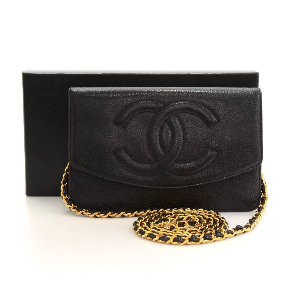 Chanel black caviar leather wallet on chain. It has flap top with a secure stud and 1 zipper pocket on the back. Inside has 1 compartment for coin with zipper closure, 3 note compartments, and 6 card holders. It has long chain intertwined with