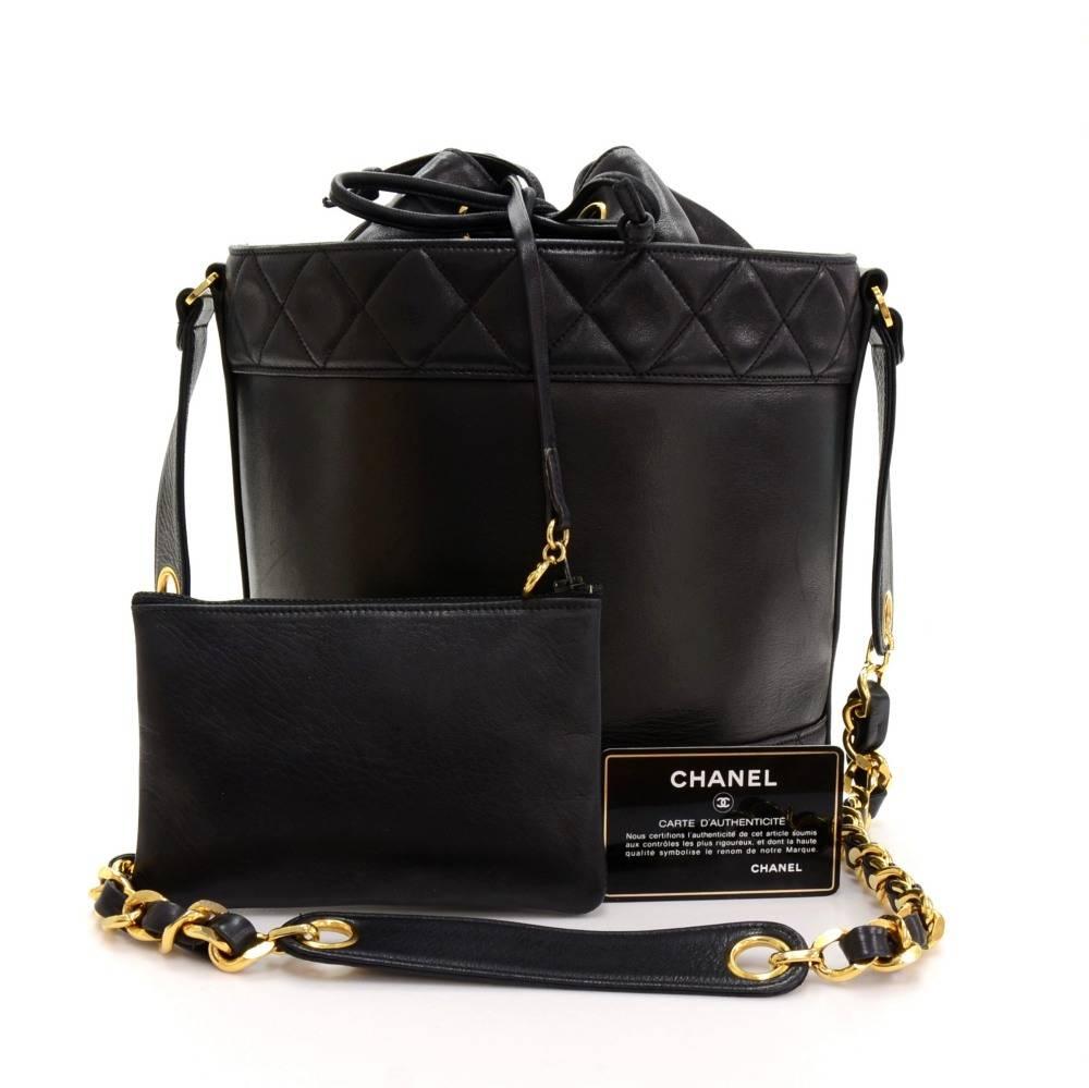 Chanel shoulder bucket bag in black lambskin leather. Main access has leather string closures. Inside has leather lining with 2 zipper pockets and attached small pouch. Comfortably carried on one shoulder.

Made in: Italy
Serial Number: Hard to