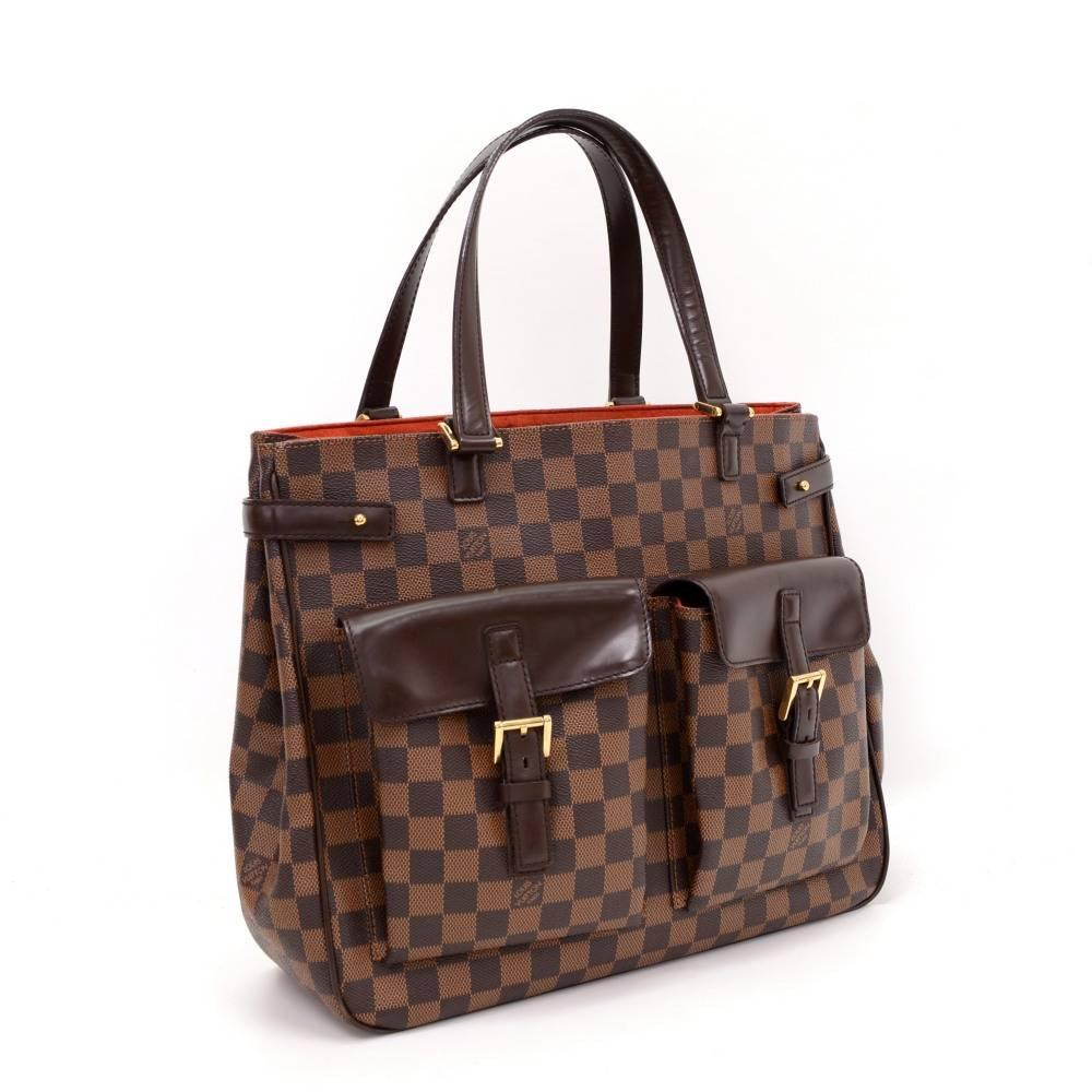 Louis Vuitton Uzes tote bag in Ebene Damier canvas. It has 2 small pocket with flap and belt closure on front. Open access. Inside has red alkantra lining with 1 zipper pocket and 1 for mobile. Great for daily use.

Made in: France
Serial Number: