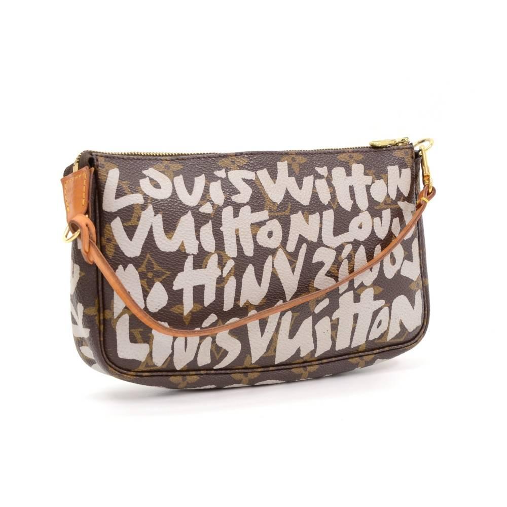 Louis Vuitton pochette accessories in monogram graffiti collection from 2001. It stores beauty products and other daily essentials. Perfect for night out and parties. It can be either hand-held or linked to the D-ring found in many Louis