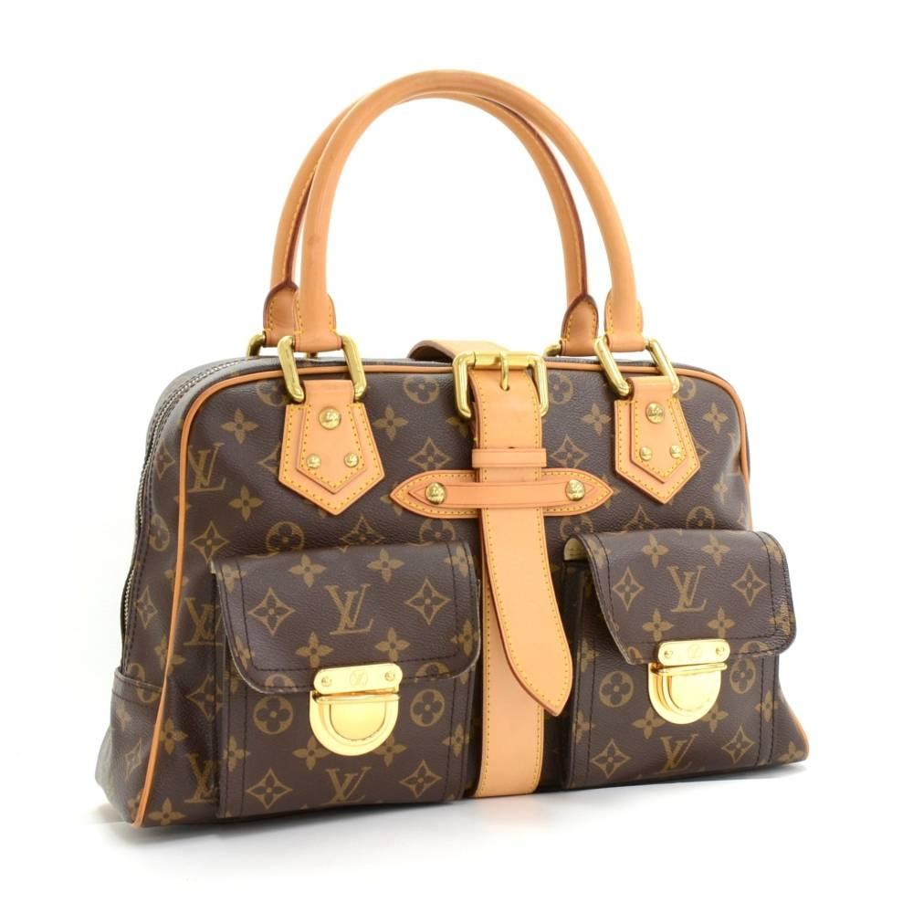 Louis Vuitton Manhattan GM in monogram canvas. Zipper closure is secured with a leather belt. On the front has 2 flap pockets with clutch closures. Inside has alkantra lining and 1 open pocket. 

Made in: France
Serial Number: BA0065
Size: 15 x