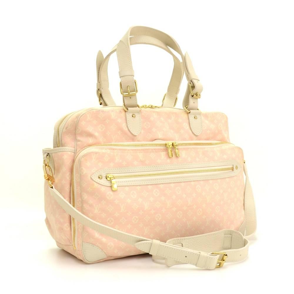 Louis Vuitton Sac A Langer diaper bag in pink Monogram Mini Line. Outside has 2 zipper pockets on front and 1 open slip pocket on back. Top is secured with double zipper. Inside is in pink fabric lining with 3 open pockets and 2 rubber band for