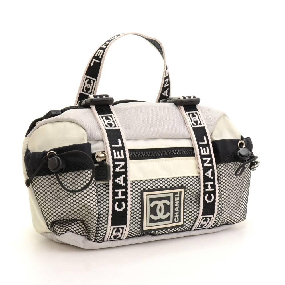 Chanel sports line waist bag in gray x white canvas. It has 2 small open pockets 1 with zipper on front. Main access has zipper. Can carried around waist by hook. Very stylish and cute!! 

Made in: France
Size: 11.8 x 6.3 x 2.8 inches or 30 x 16 x 7