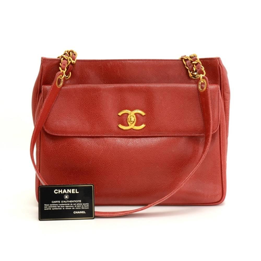 Chanel tote in red caviar leather. It has 1 flap pocket with CC twist lock in front and open pocket on the back. Main access secured with 2 magnetic closures. Inside has leather lining and 2 zipper pockets. Comfortably carried on shoulder and offers