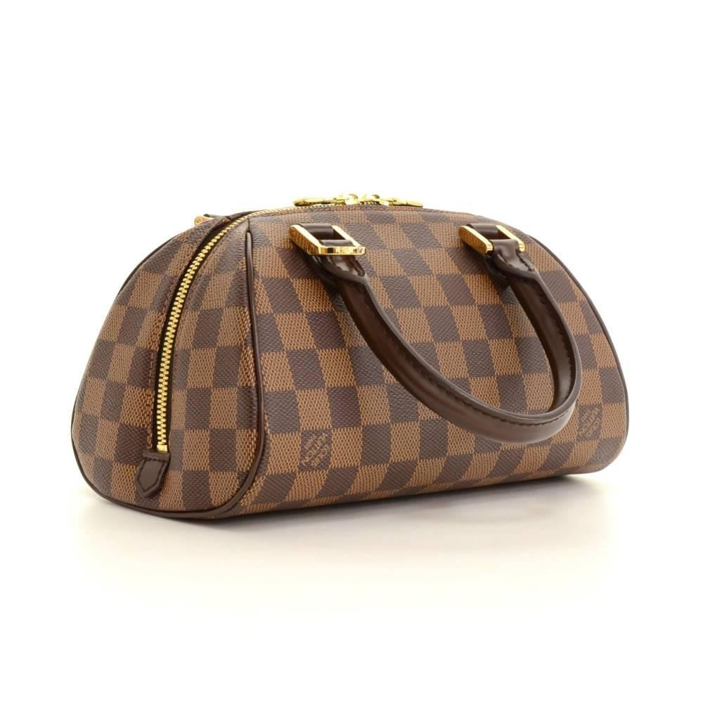 Louis Vuitton Mini Ribera hand bag in damier Canvas. Top is secured with double zipper. Inside is in red canvas lining with 1 open pocket. Perfect for daily use or night out.

Made in: Spain
Serial Number: CA0075
Size: 8.7 x 4.7 x 5.1 inches or 22 x