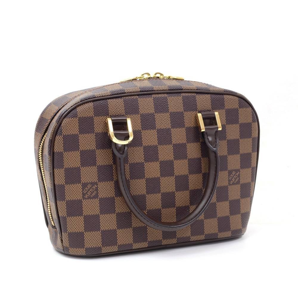 Louis Vuitton Sarria Horizontal hand bag in damier canvas. Top access is open with double zipper. Inside is in red alkantra lining with 1 open pocket. Perfect to carry all your daily necessities. 

Made in: Spain
Serial Number: CA0033
Size: 9.4 x