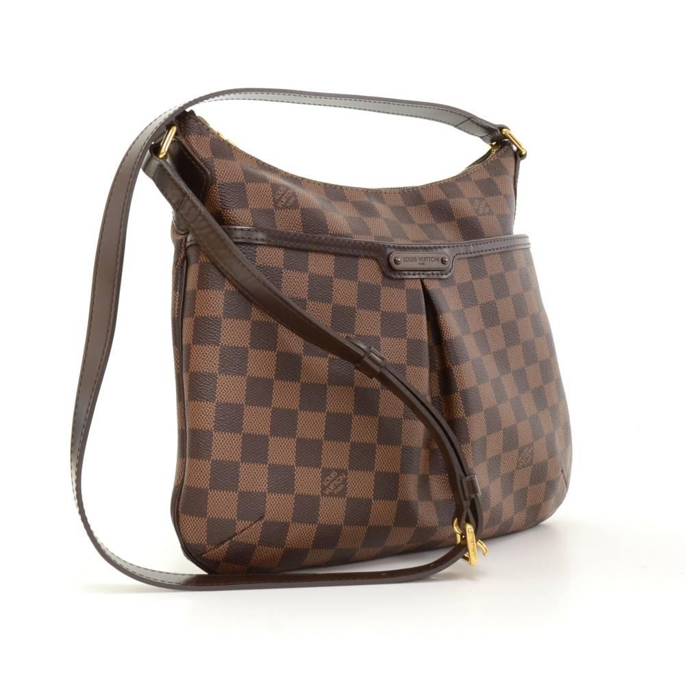 Louis Vuitton Bloomsbury PM shoulder bag in brown Damier canvas. Top is secured with double zipper and 1 slip pocket with stud closure on front. Inside is in red lining with 1 open pocket and 1 pocket for mobile or glasses. Comfortably carried on