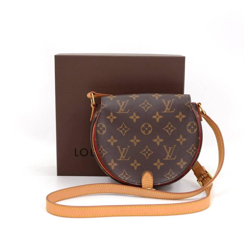 Louis Vuitton Tambourine shoulder bag in monogram canvas. Simple flap closure secured with belt type buckle. Inside is red alkantra lining with one open pocket. Comfortably carried on one shoulder or across body with adjustable strap. Wonderful