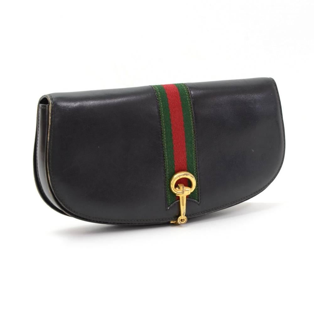 Gucci black leather ribbon clutch bag. Top is secured with flap and clip closure. Inside is red leather lining and 1 zipper and 2 open pockets. Stunning clutch bag to use. 

Made in: Italy
Size: 9.4 x 4.7 x 1.2 inches or 24 x 12 x 3 cm
Color: