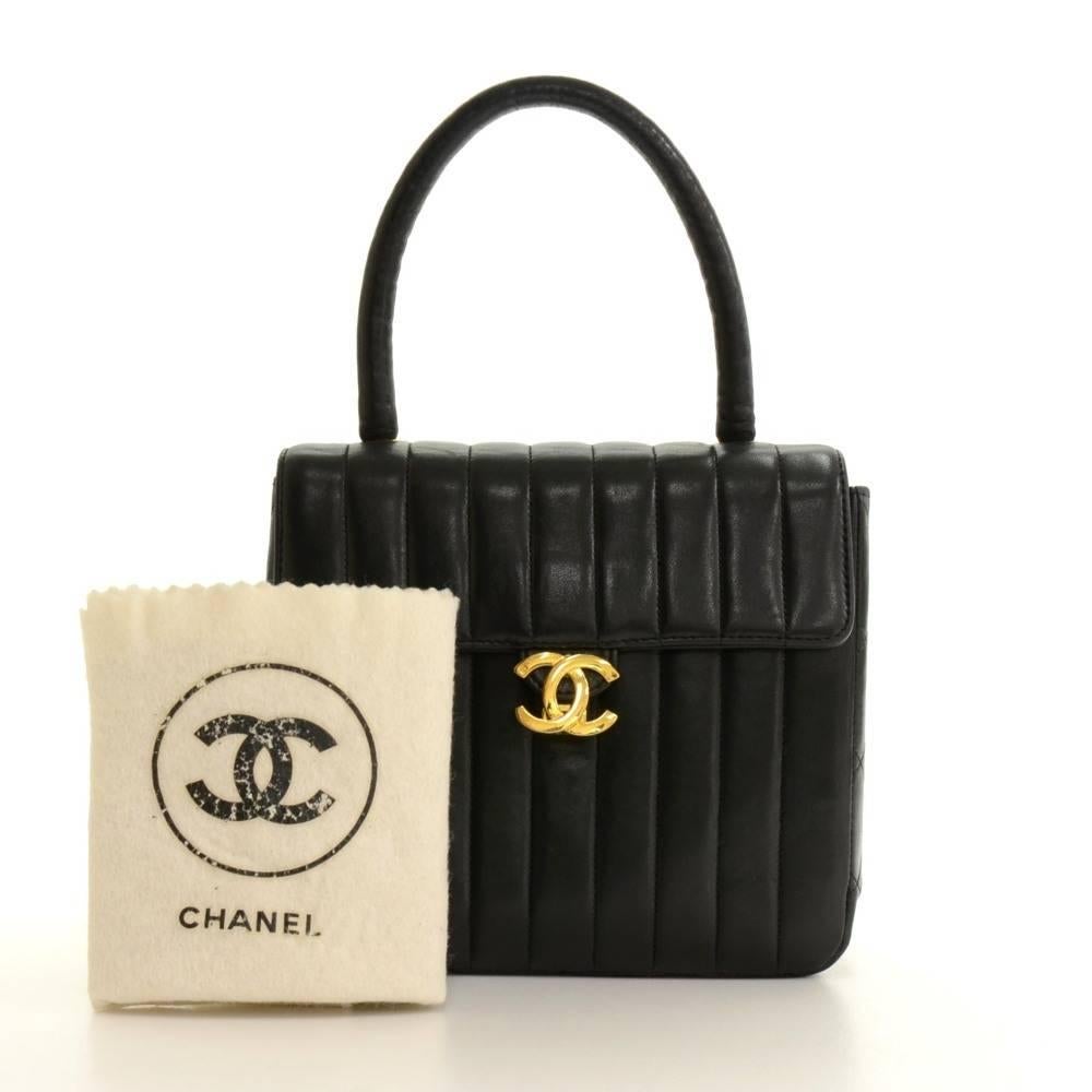 Chanel handbag in lambskin vertical quilted leather. CC logo lock on the front. On the inside, it has Chanel red leather lining with 2 interior pockets; 1 open and 1 zipper. Very stylish and classic Chanel design. 

Made in: France
Serial Number: