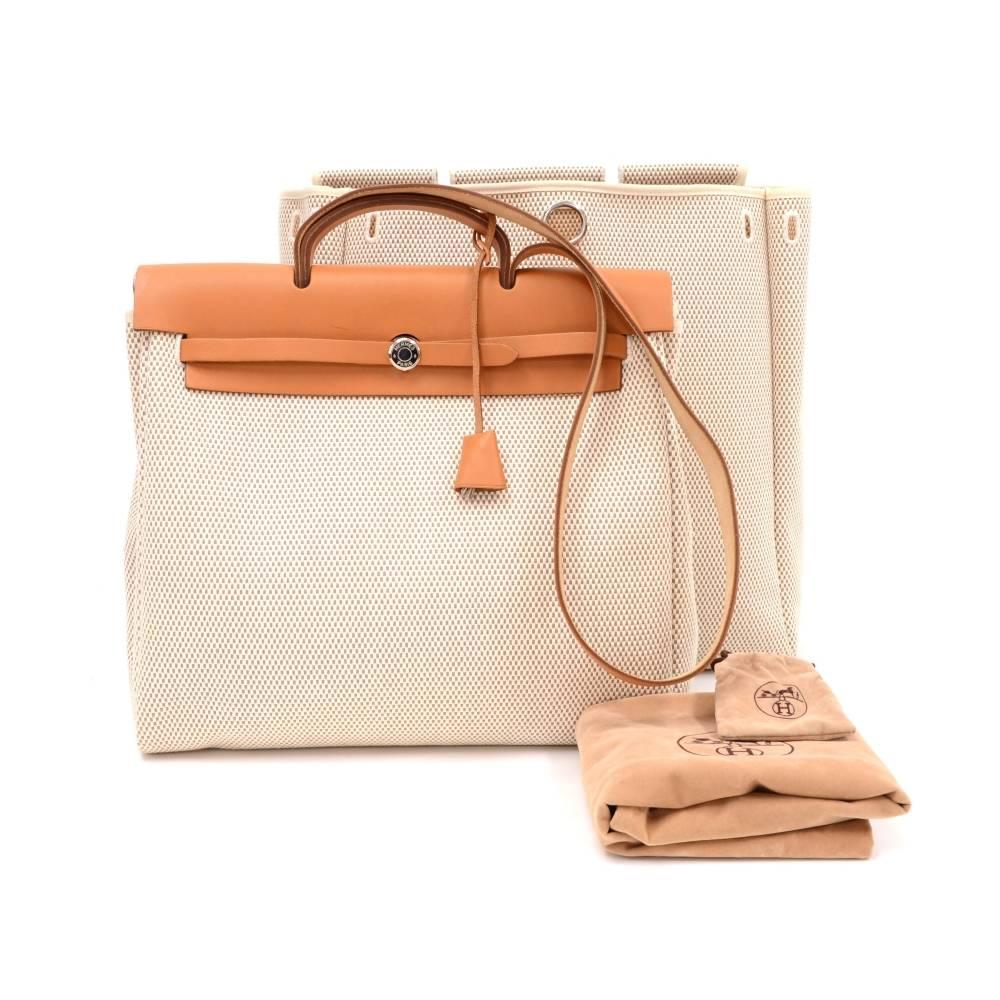 Hermes HerBag MM size 2 in 1. Two canvas bags with leather. Leather pieces can be attached to both bags so you can enjoy different looks. Very stylish bag. Tall Canvas bag: App 15 x 12.5 x 5.5 inches or 38 x 38 x 14 cm Large Canvas bag: App 15 x 15